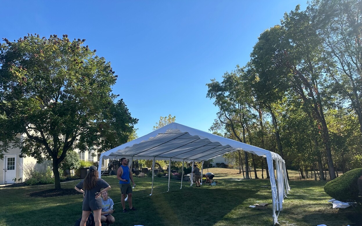 20x40 white event tent fully assembled in a backyard